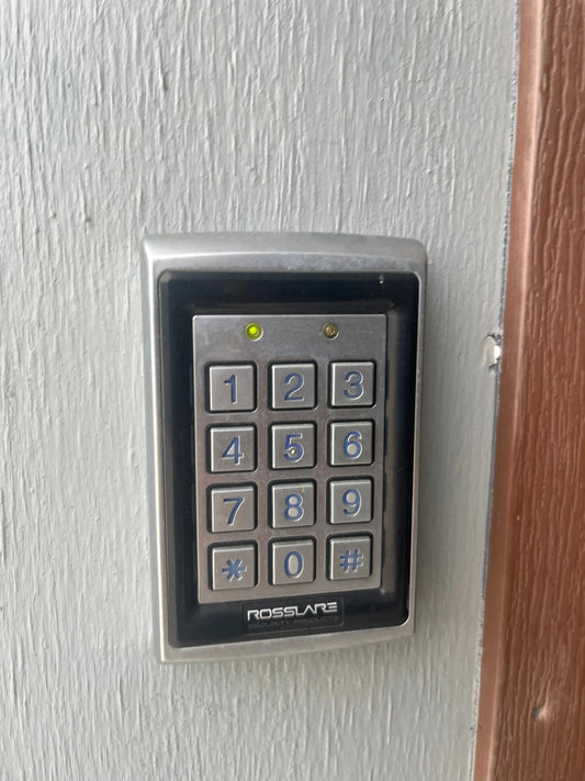 Austin office door with card reader—user unlocking via mobile credential for secure access control.
