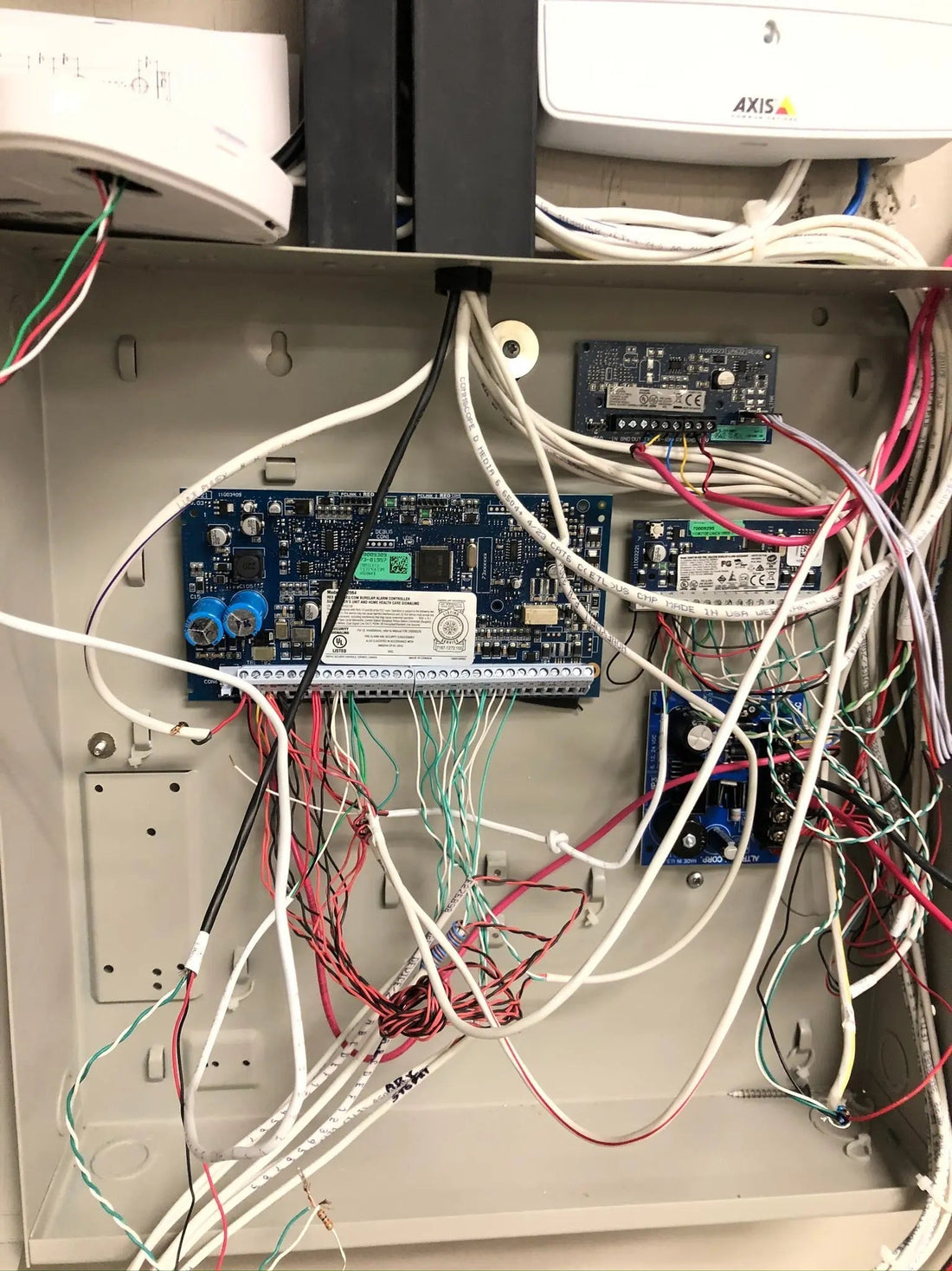 Avenger Security technician installing an access control reader at an Austin, TX business.