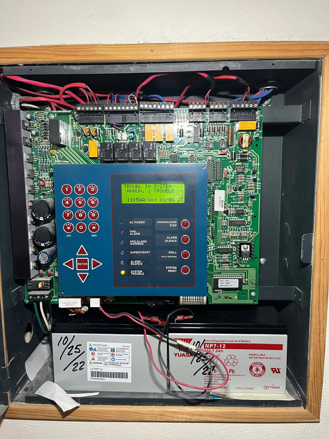 Commercial fire alarm control panel with pull station and communicator in an Austin, TX business, monitored by a UL central station.